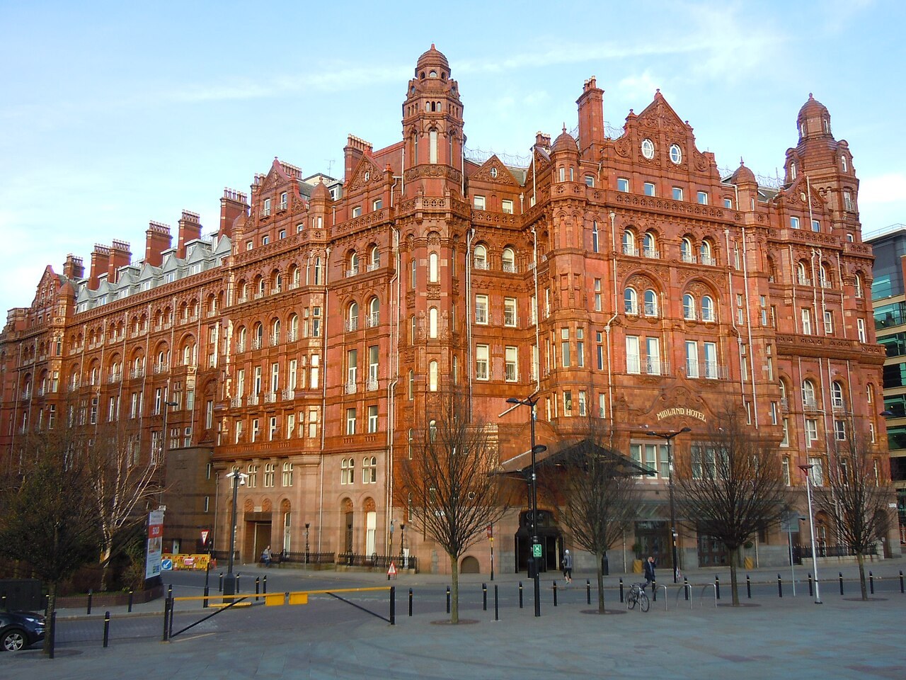 The ornate red and pale stone exterior of the Midland Hotel in Manchester.
